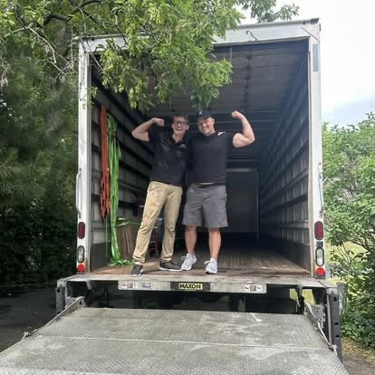 Two Peak Movers team members having fun in the back of the moving truck