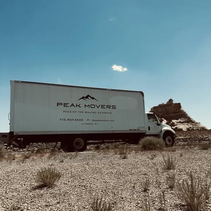 Peak Movers truck on a long-distance haul across an open landscape