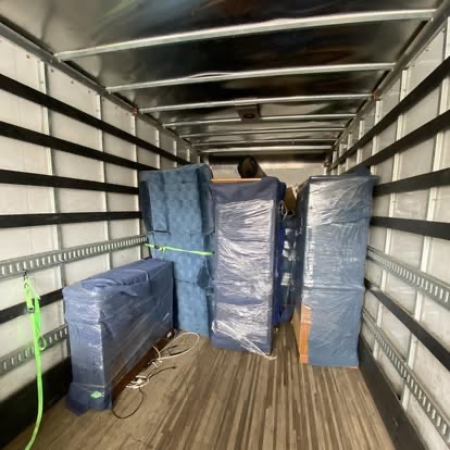 Furniture professionally wrapped and strapped inside a loaded Peak Movers truck