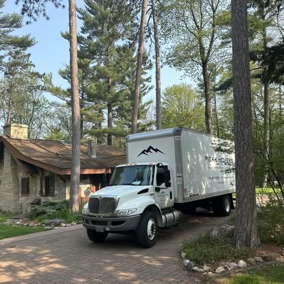 Peak Movers truck parked in the driveway of a Wisconsin home during a residential move